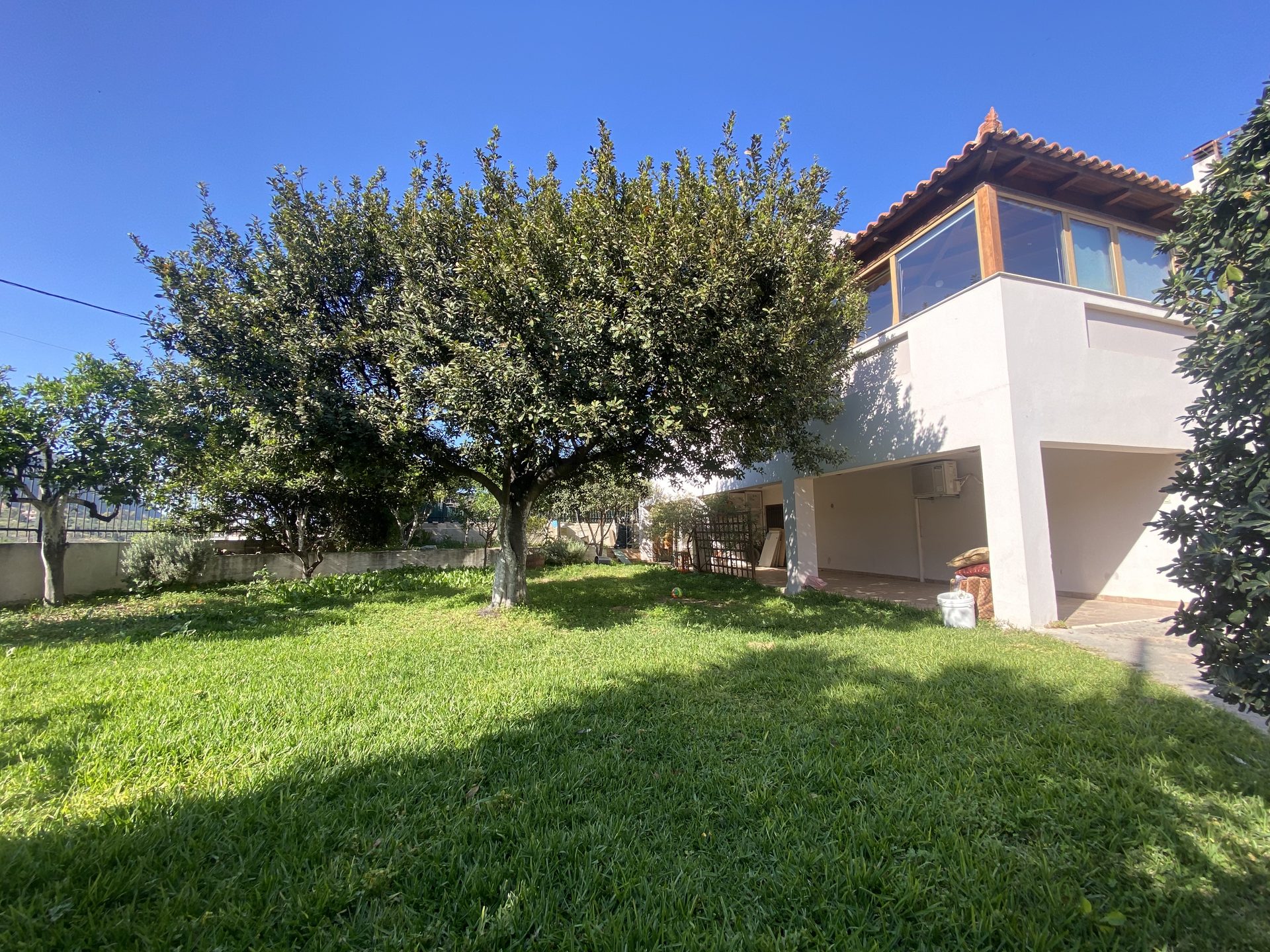 Two-story house with garden, viewed from the village street