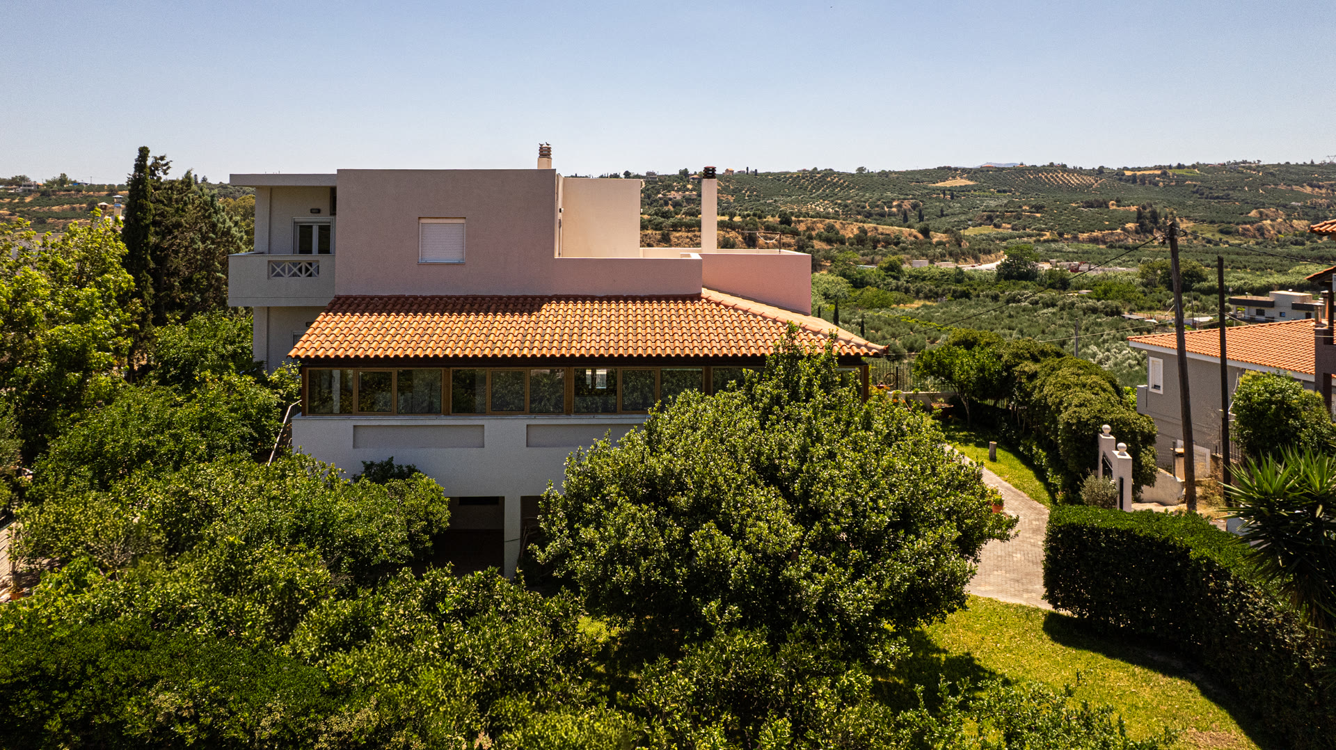 Aerial view of the Kavrochori house set among mature greenery and olive-grove views