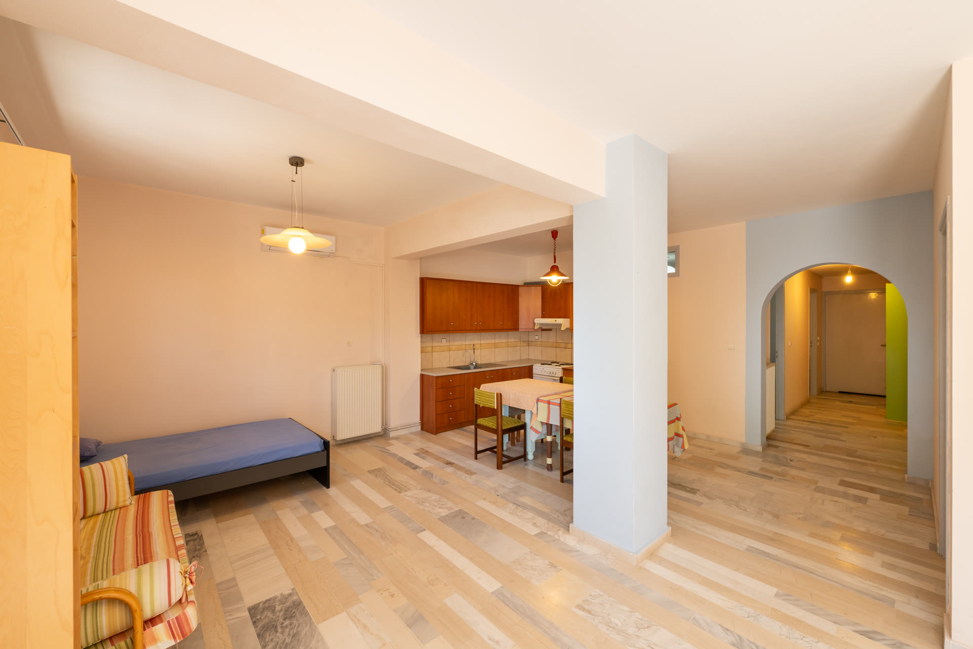 Garden-level apartment living area with kitchenette, seating, and separate entrance use