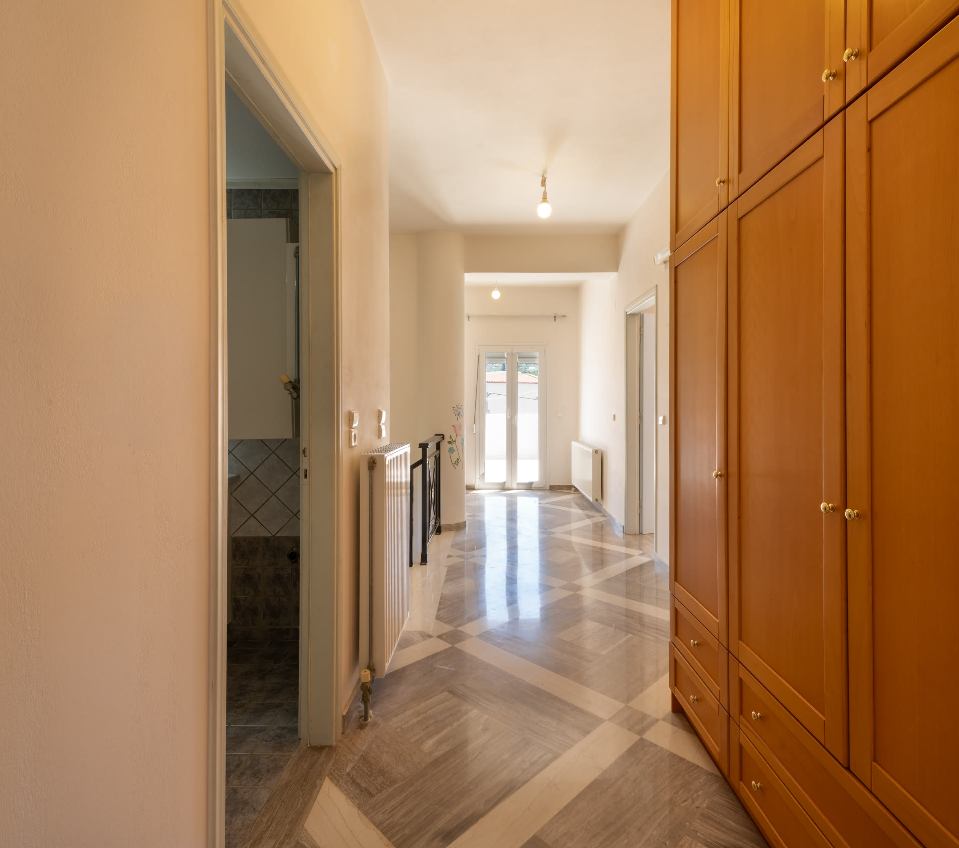 Upper hallway with built-in wardrobes and sightline through the house