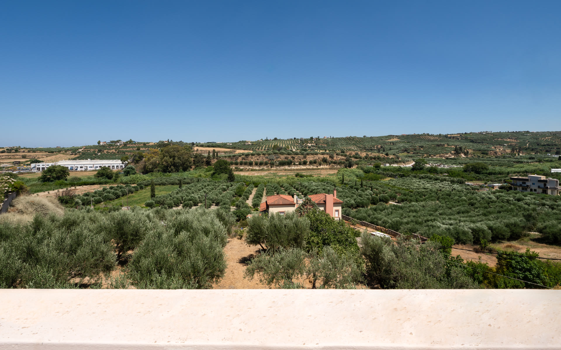 Open view from the terrace across olive groves and the surrounding countryside