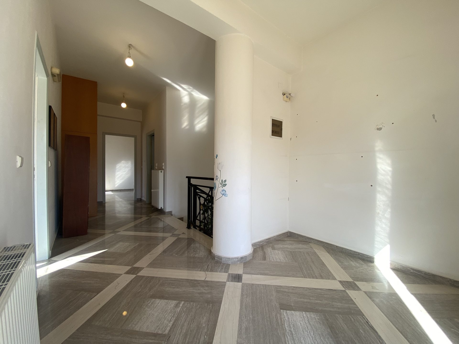 Upper-floor landing with internal column and access to staircase