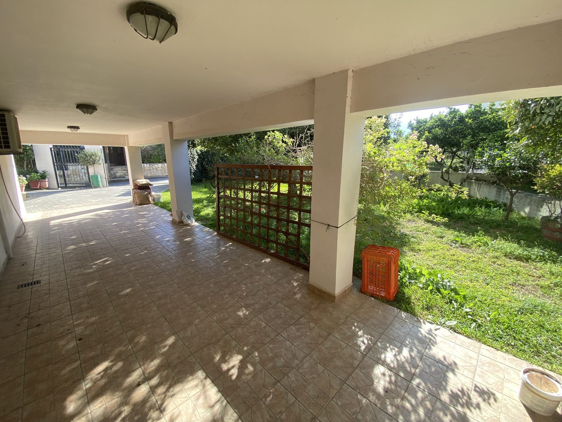 Covered terrace on columns with garden view